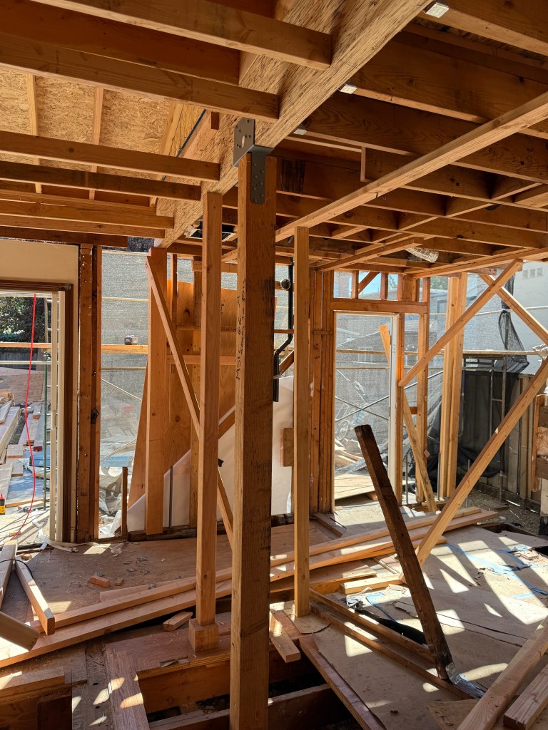 Framed floor opening showing underfloor access during remodel — Hand + Hammer Development